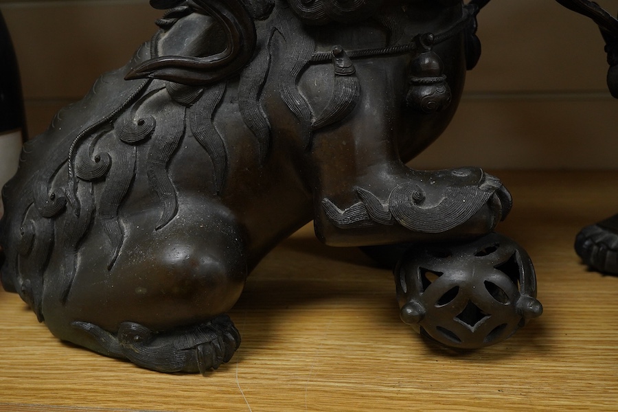 A pair of large 19th century Chinese bronze lion dogs, 26cm